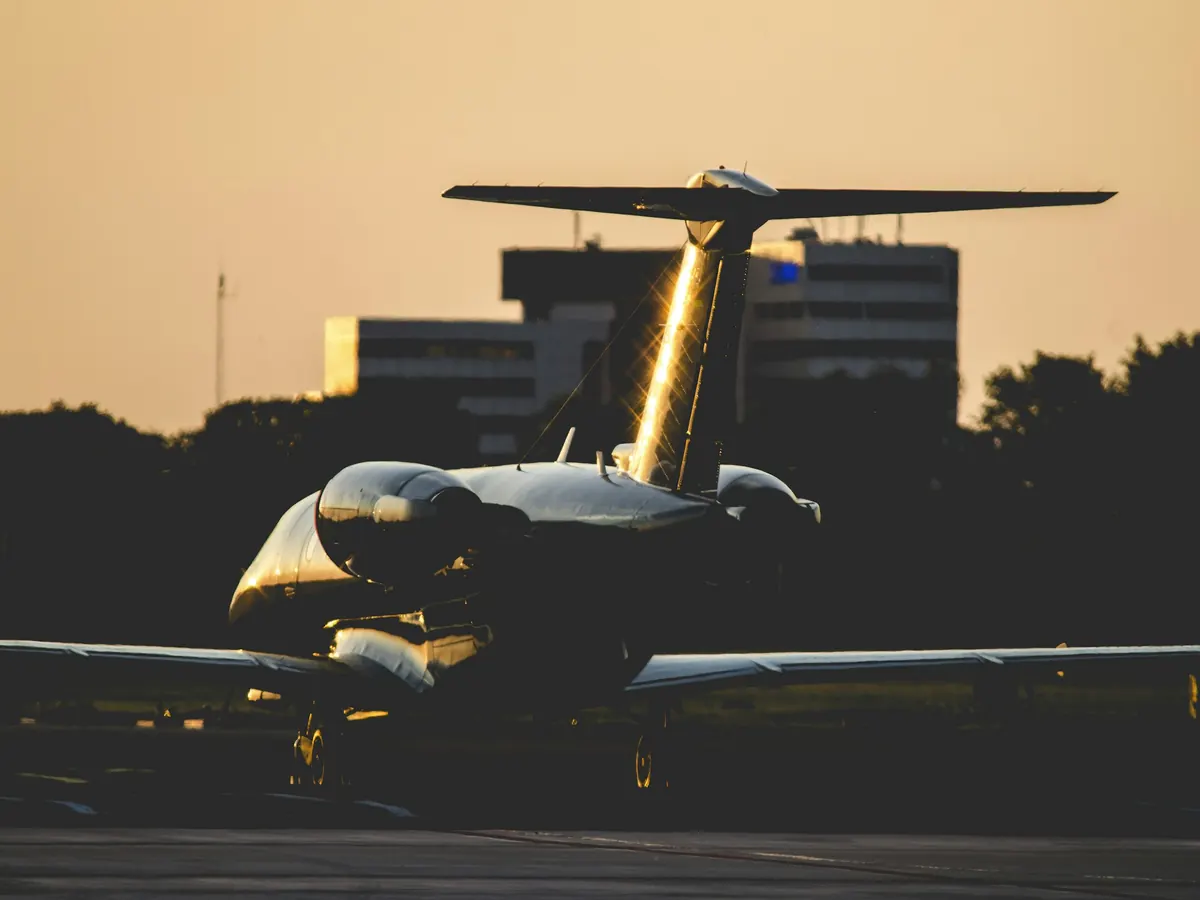 A light jet lit gold by the setting sun