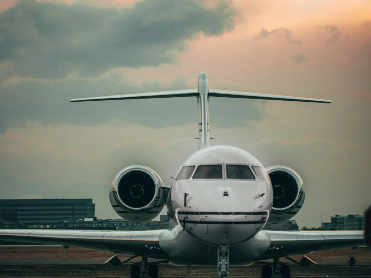 A business jet facing the camera on a ramp at dusk